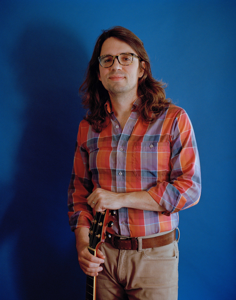 Matt standing with his Sadowsky guitar.