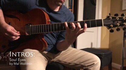 Matt playing his Sadowsky archtop in his office at night with a warm colored light.